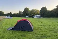Swallow Bach grass pitches with tents and tourers welcome