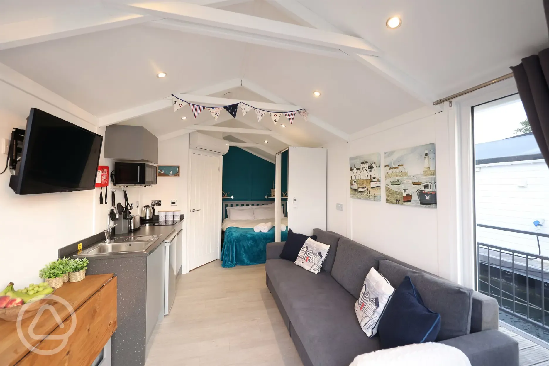 Marine ensuite glamping lodge interior, with open plan living space and kitchen