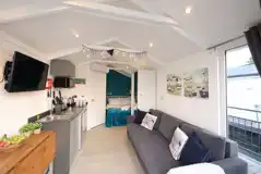 Marine ensuite glamping lodge interior, with open plan living space and kitchen