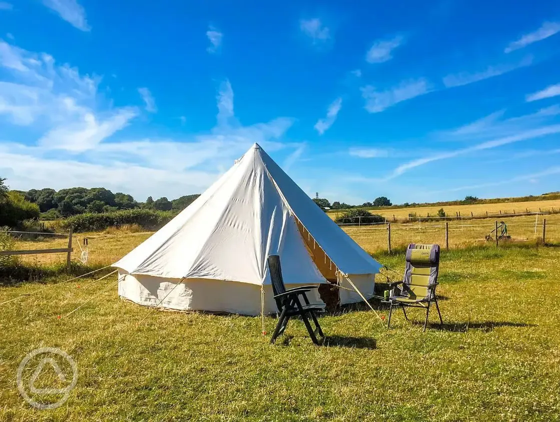 Bell tent exterior with outdoor seating 