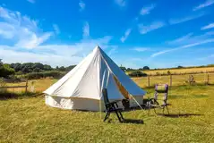 Bell tent exterior with outdoor seating 