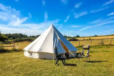 Bell tent exterior with outdoor seating 