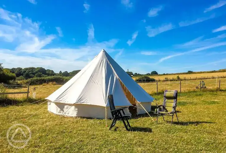 Bell tent exterior with outdoor seating 