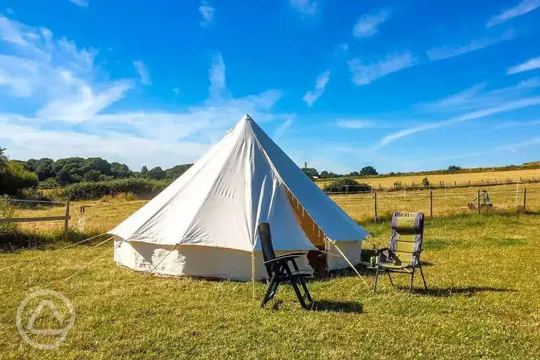 Bell tent exterior with outdoor seating 