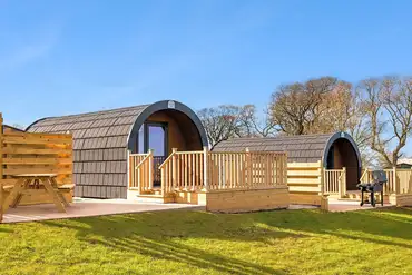 Glamping pod exterior with private decking and outdoor seating
