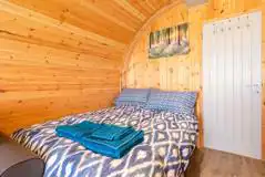 Glamping pod double bed with linen and towels provided