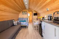 Glamping pod interior with double bed and double sofa bed for children