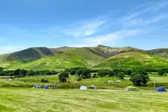 Non electric grass pitches with views of the Lake District National Park