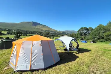 Non electric grass pitches with mountain views and measuring 6m x 6m