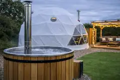 Glamping dome with a wood-fired hot tub