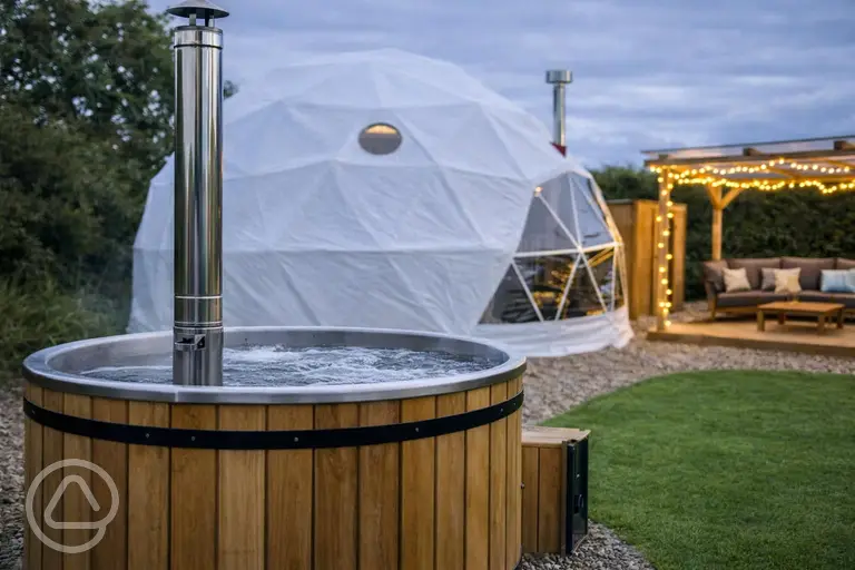 Glamping dome with a wood-fired hot tub