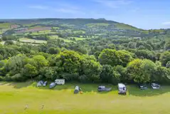 Grass pitches (optional electric) by the woodland borders of the field