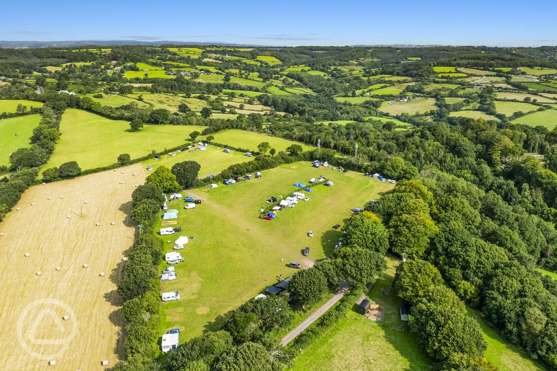 Aerial of the campsite with surrounding farmland, hedges and trees