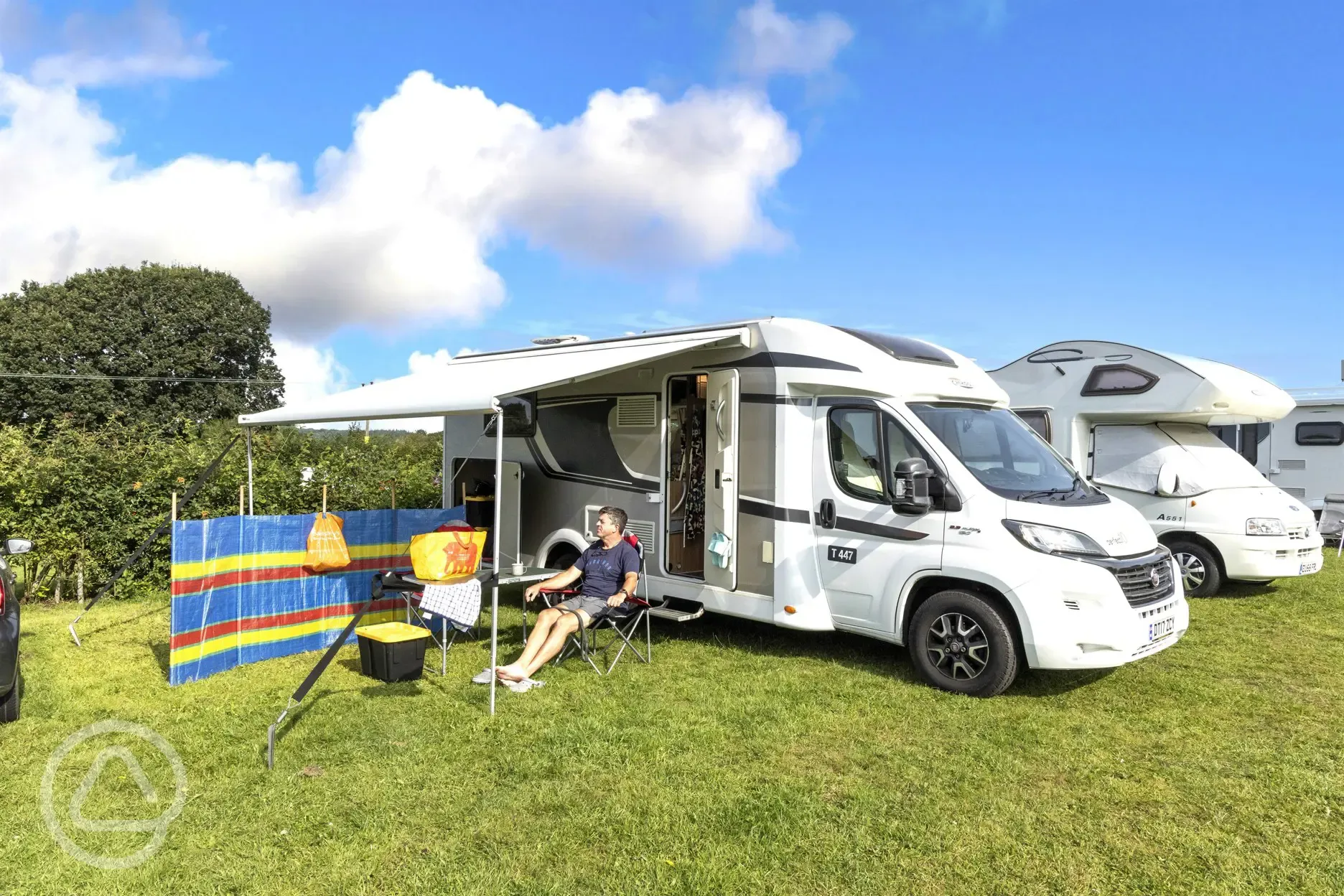 Non electric grass pitches with a motorhome and awning