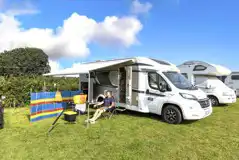 Non electric grass pitches with a motorhome and awning