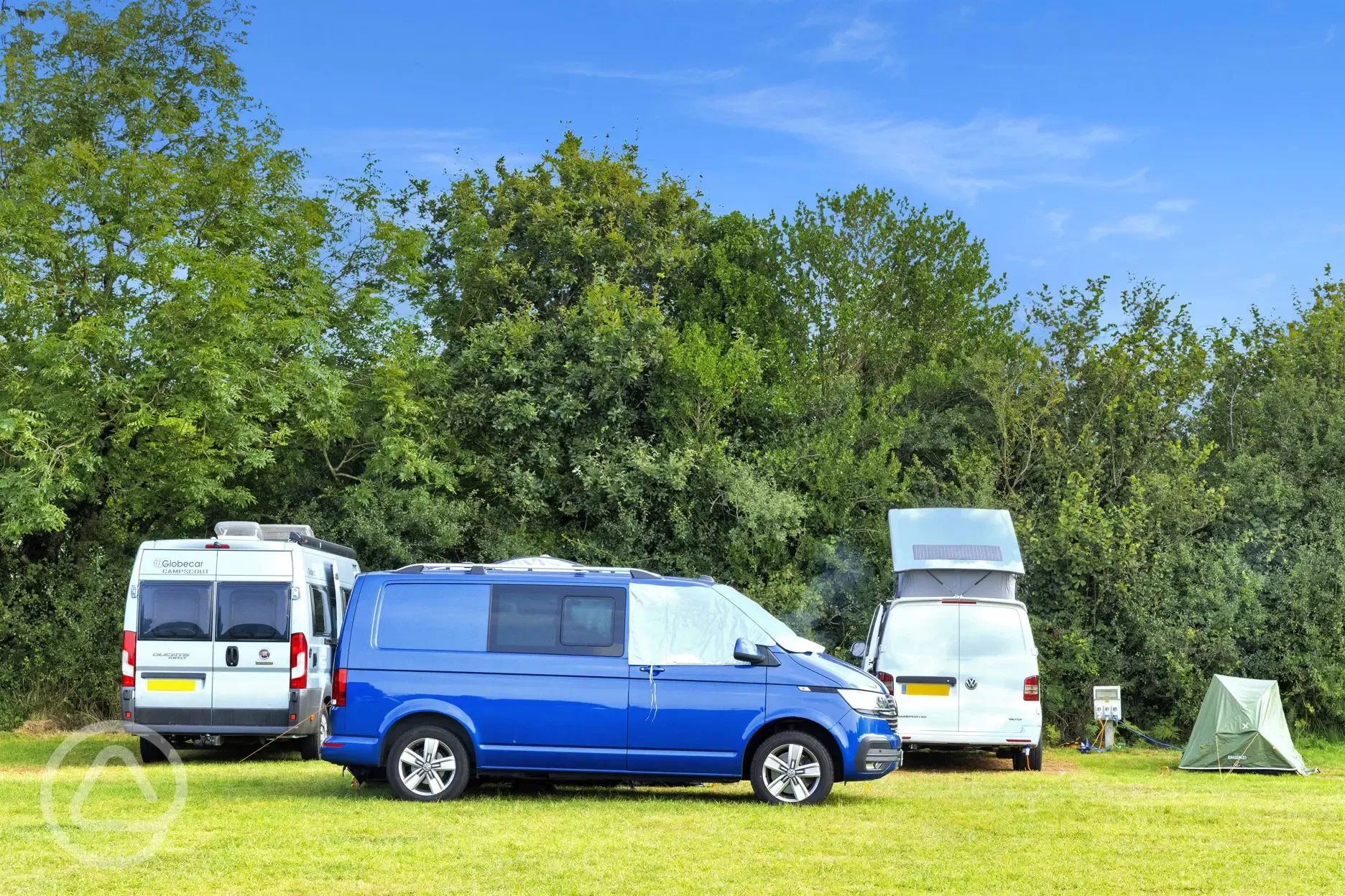 Grass pitches (optional electric) with campervans and motorhomes