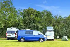 Grass pitches (optional electric) with campervans and motorhomes