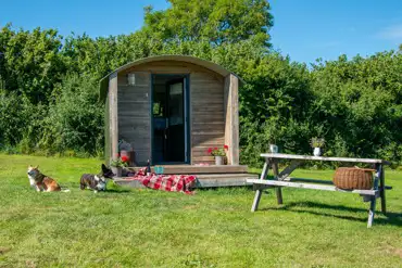 Furnished camping pods exterior with a picnic bench (dog friendly)