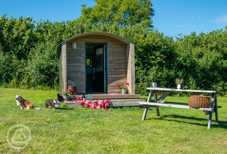 Furnished camping pods exterior with a picnic bench (dog friendly)
