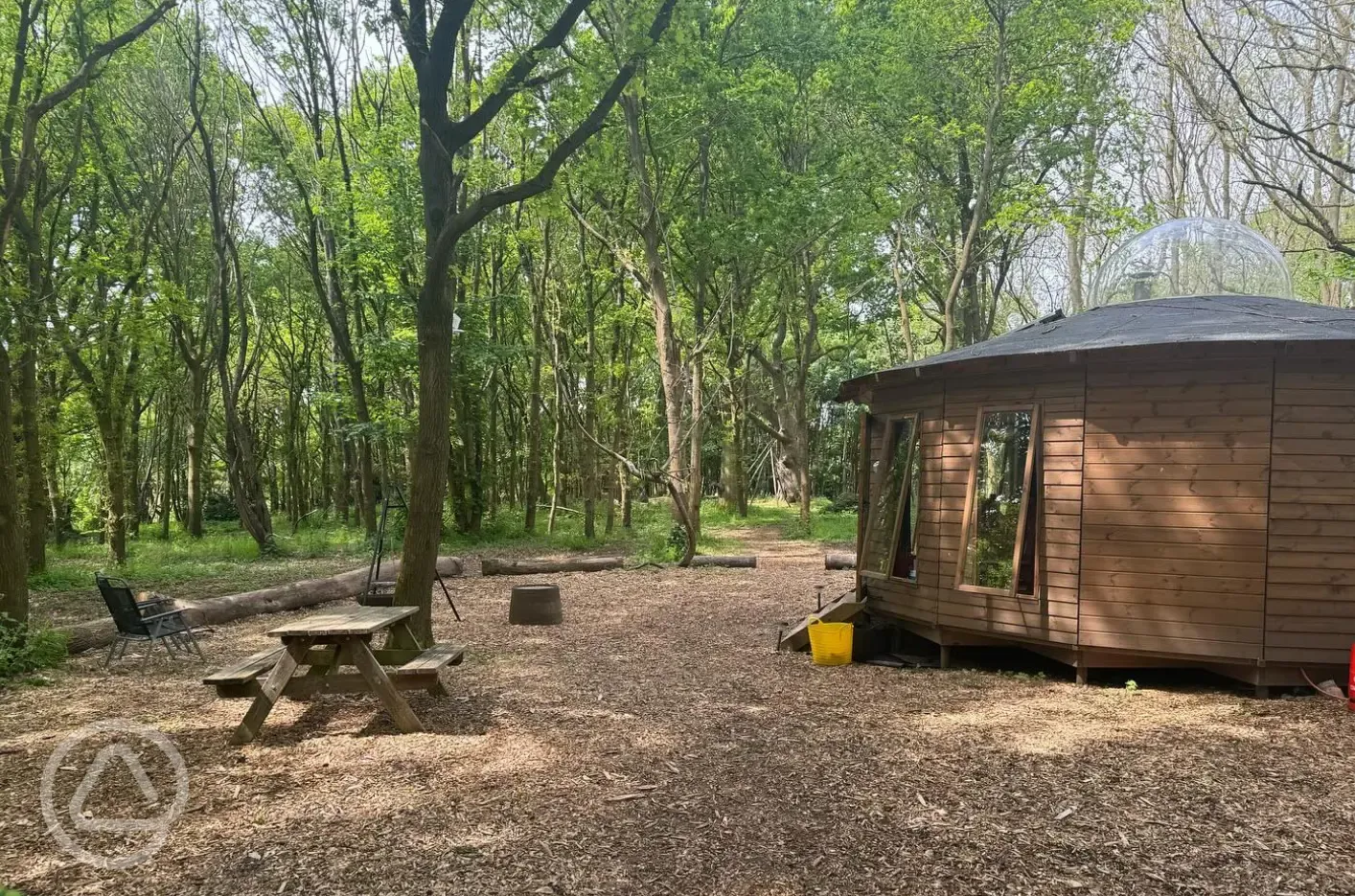 Roundhouse wooden yurt with a picnic bench