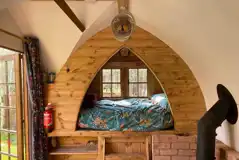 Glamping shepherd's hut interior with a double bed Glamping shepherd's hut interior with a double bed