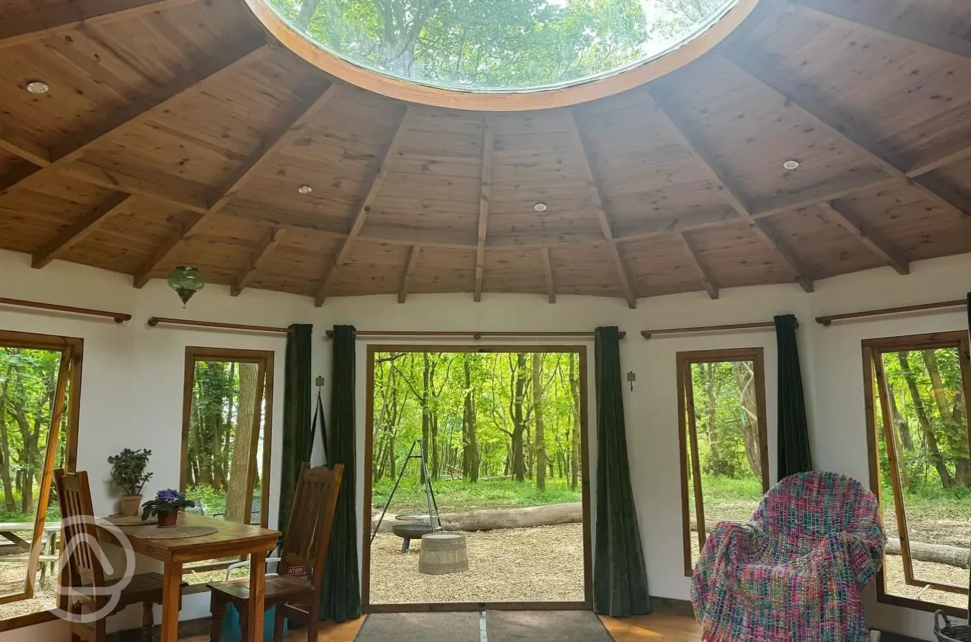 Roundhouse wooden yurt interior with a sky light