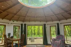 Roundhouse wooden yurt interior with a sky light Roundhouse wooden yurt interior with a sky light