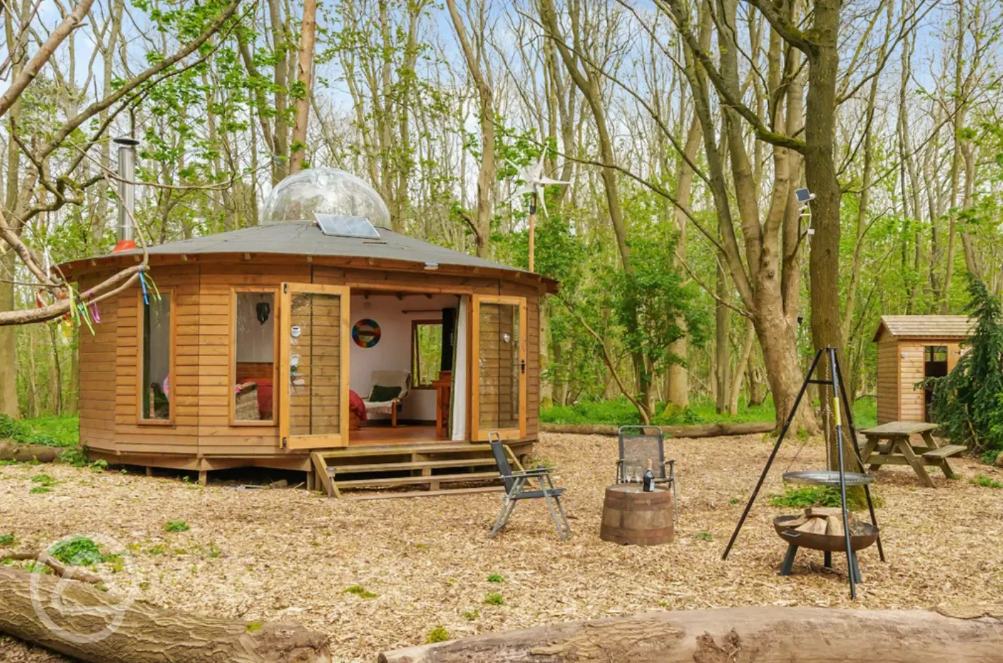 Roundhouse wooden yurt with fire pit
