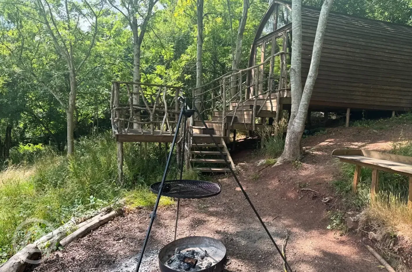 Glamping pod with outdoor fire pit area and terrace