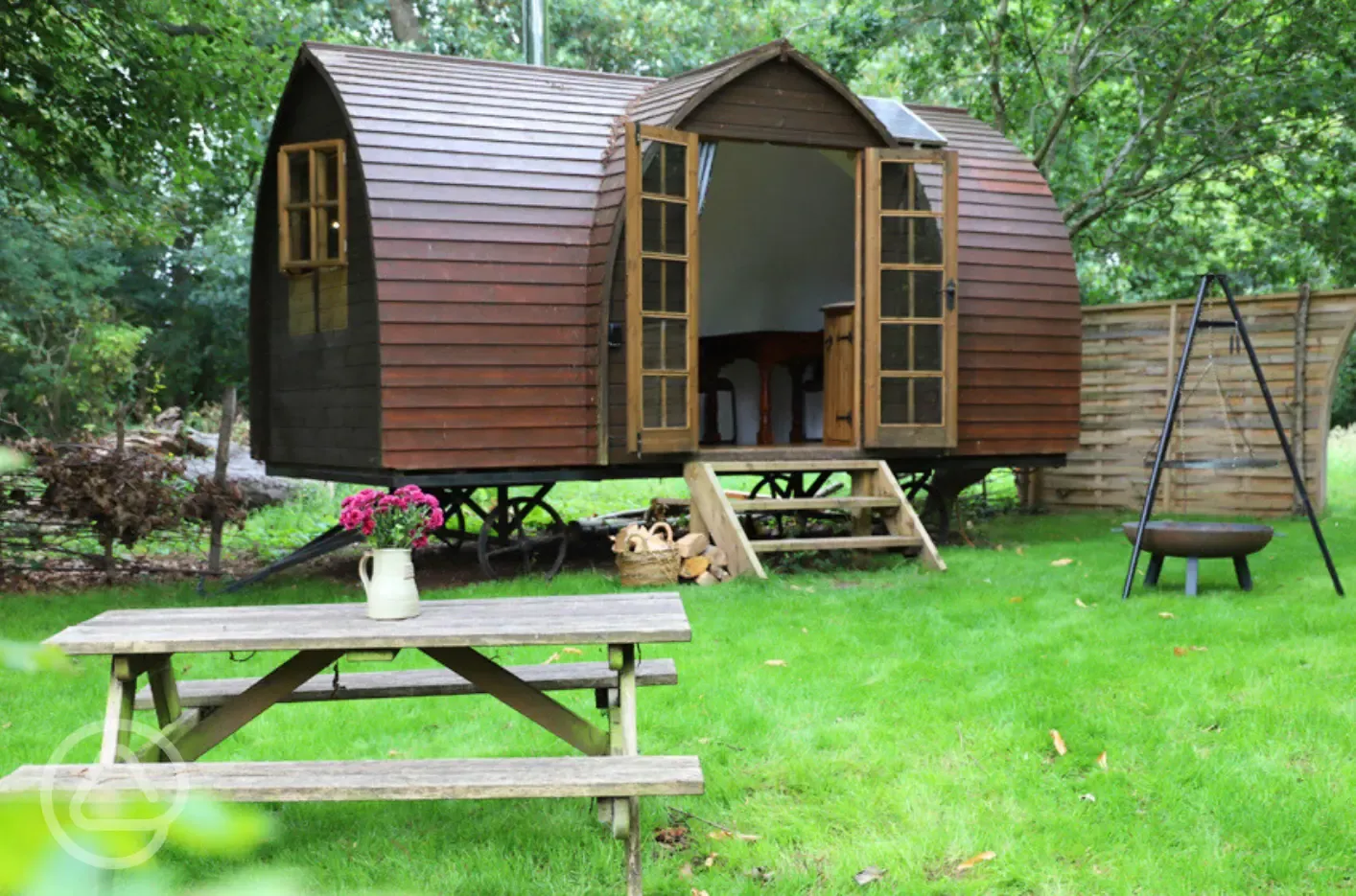 Glamping shepherd's hut with picnic bench and fire pit