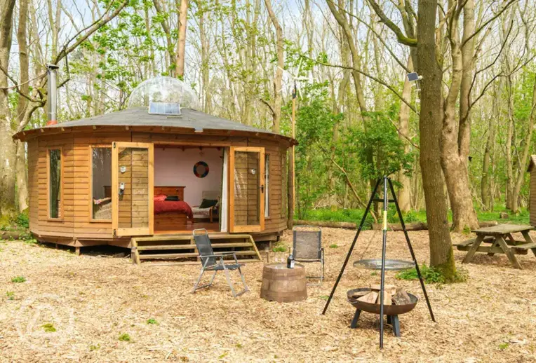 Roundhouse wooden yurt with fire pit