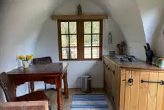 Glamping shepherd's hut kitchen and dining area Glamping shepherd's hut kitchen and dining area