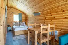 Ensuite glamping pod double bed and dining area Ensuite glamping pod double bed and dining area