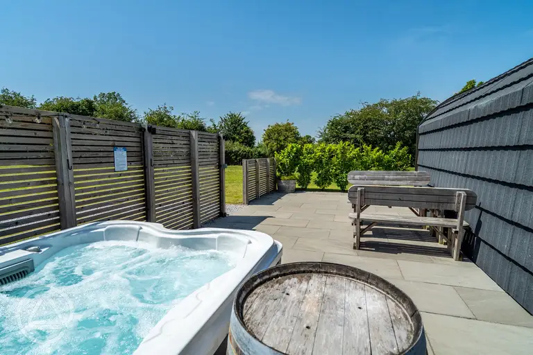 Ensuite glamping pod with private electric hot tub and seating area