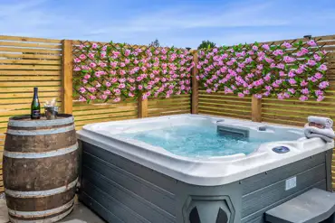 Private electric hot tub with a flower wall at Dwell On The Moor