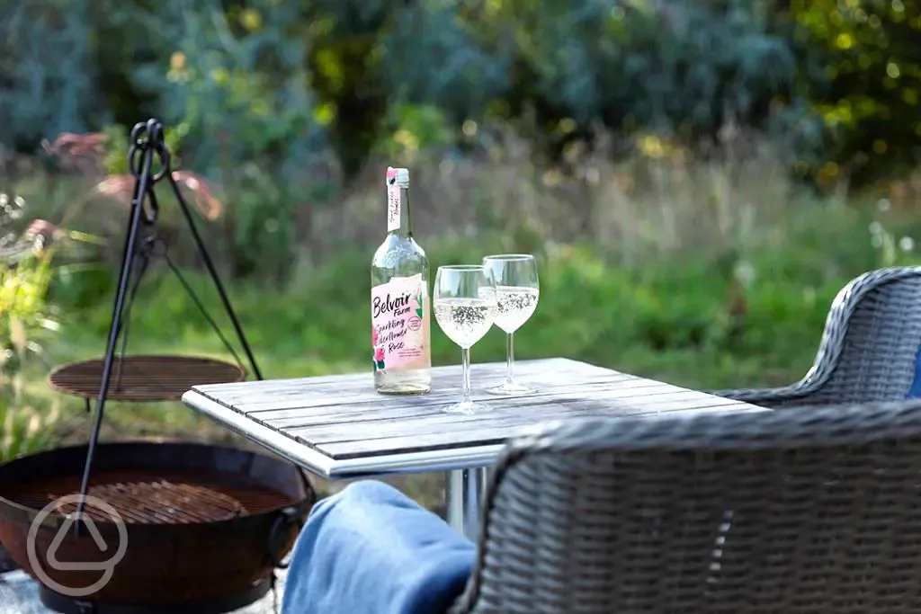 Saltmarsh shepherd's hut outdoor seating with a drink