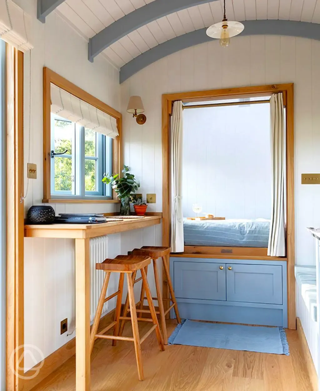 Saltmarsh shepherd's hut interior bedroom and dining bench