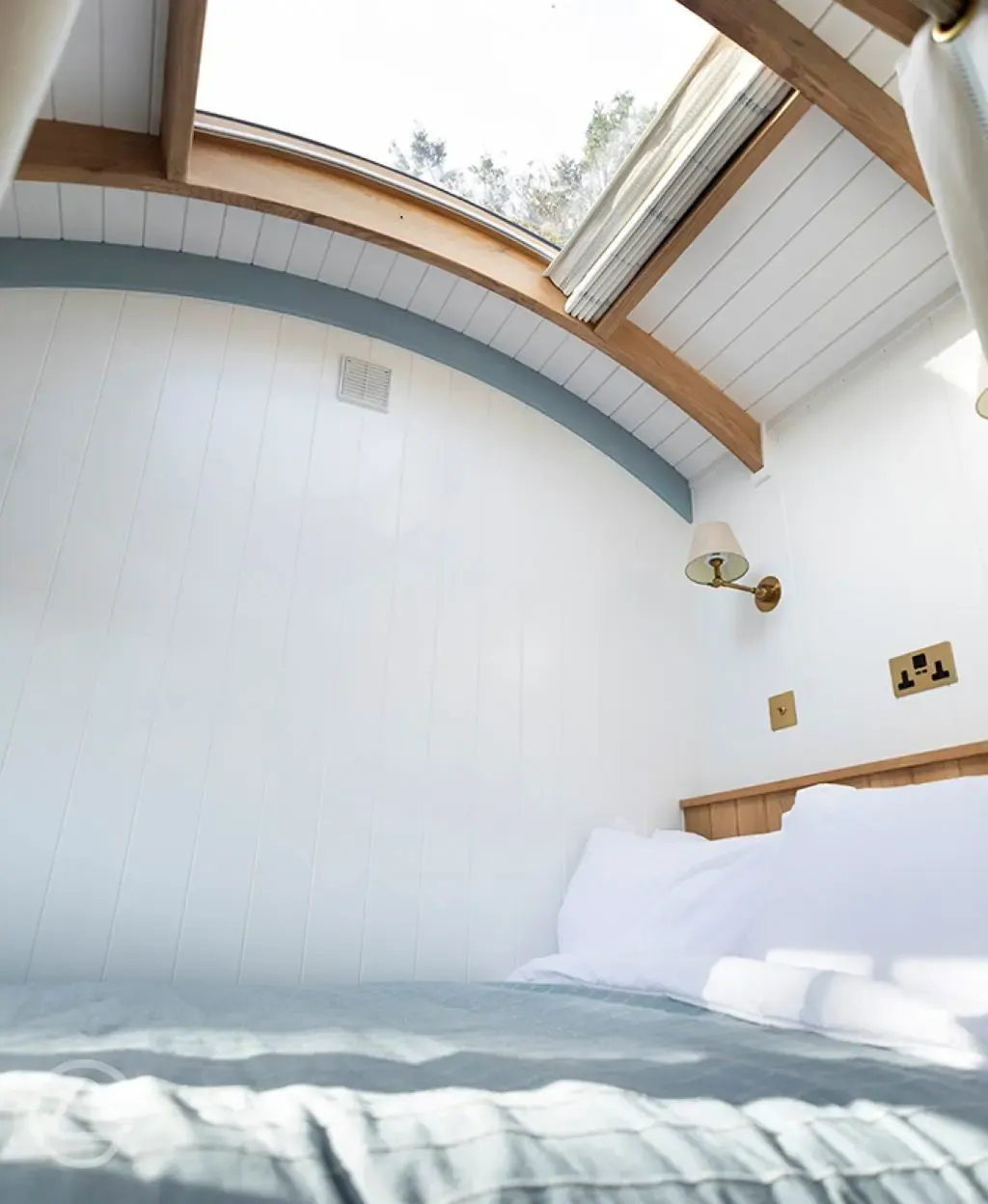 Saltmarsh shepherd's hut bedroom with stargazing window