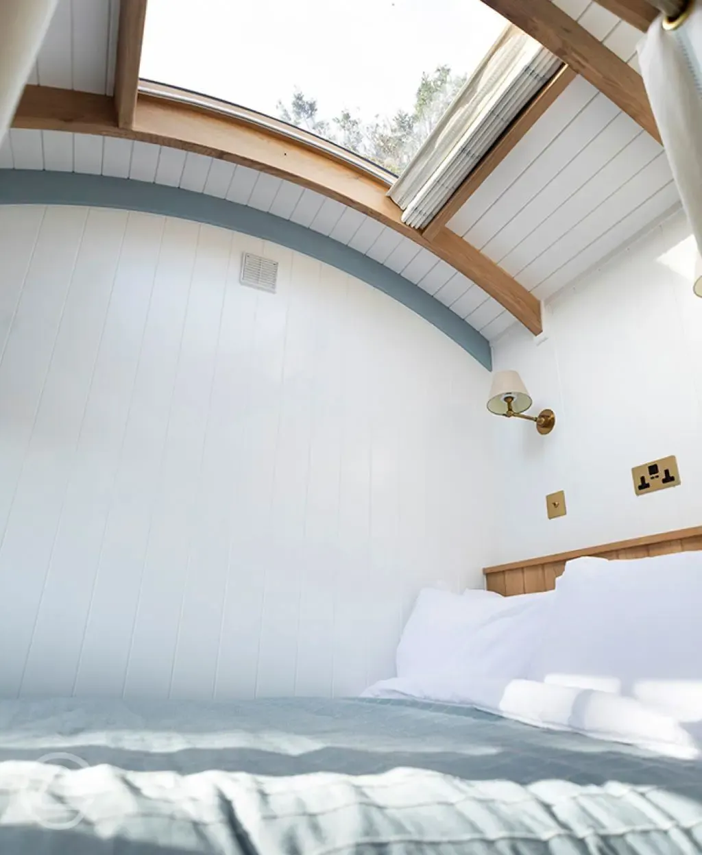 Shepherd's Hut bedroom with stargazing window