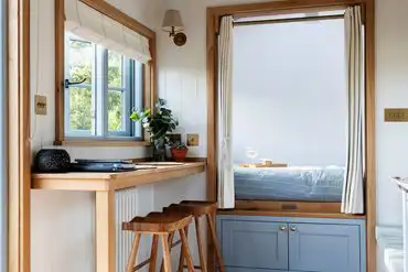 Shepherd's Hut interior bedroom and dining bench