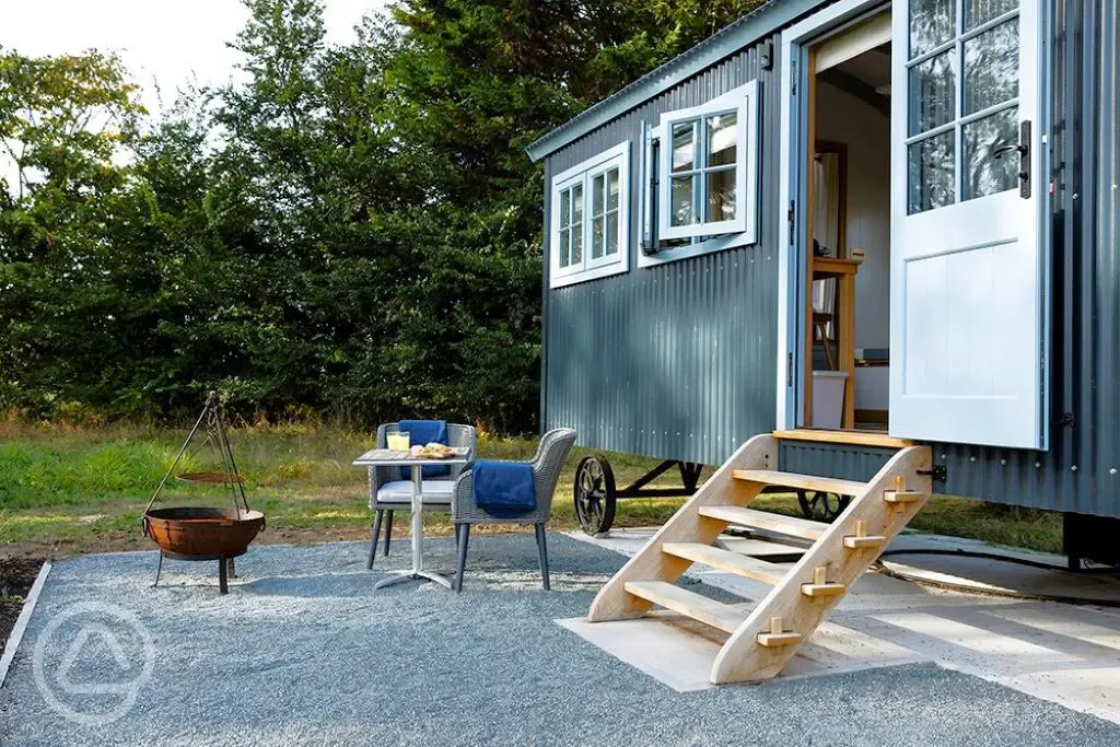 Saltmarsh shepherd's hut exterior with fire pit