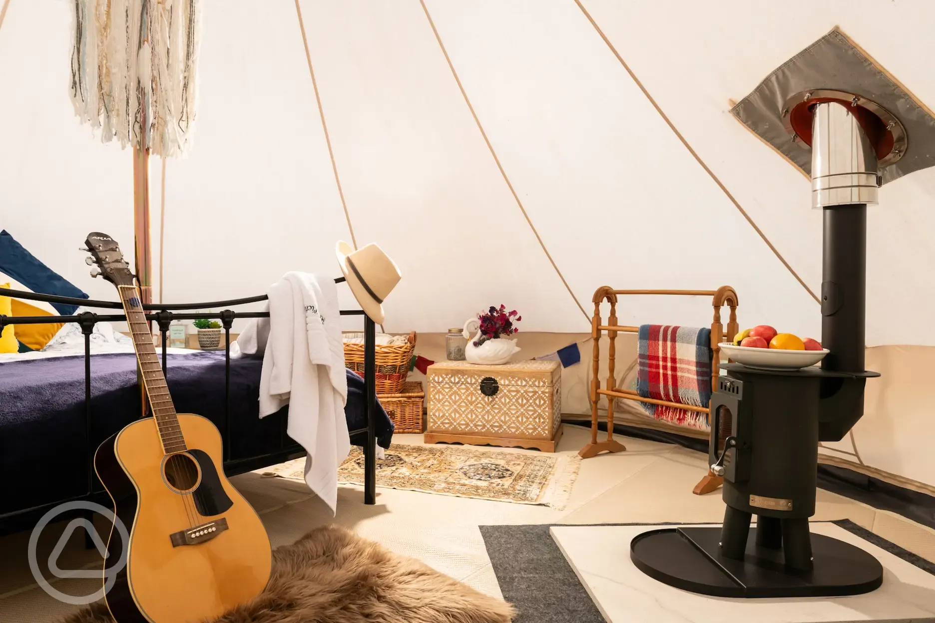 Interior of bell tent with log burner
