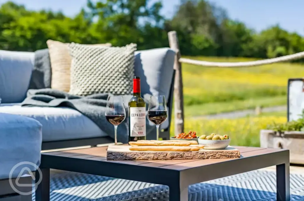Outdoor seating with wine and charcuterie