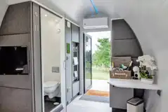 Glamping pod interior with an ensuite, TV, and coffee machine Glamping pod interior with an ensuite, TV, and coffee machine