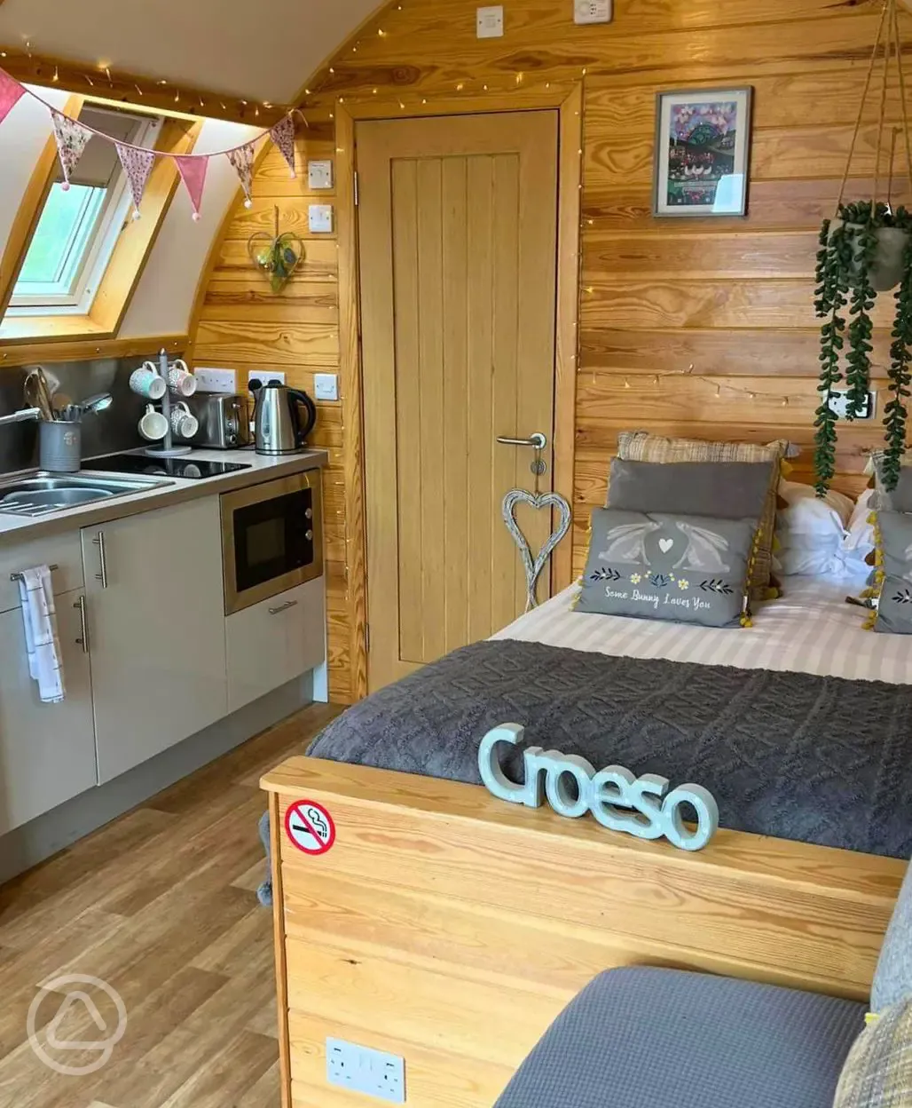 Interior of pod with bed and kitchenette