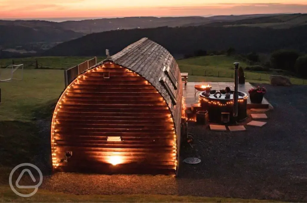 Pod at night with hot tub with views