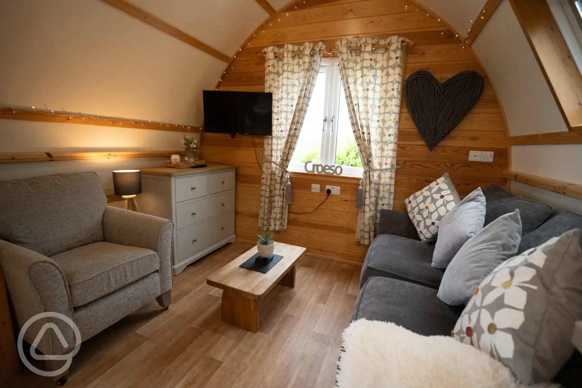 Large ensuite glamping pod sofa and TV area