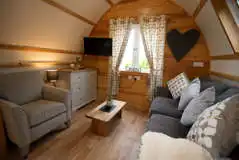 Large ensuite glamping pod sofa and TV area