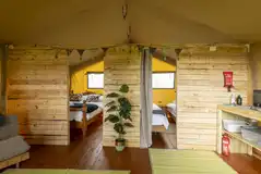 Safari tent interior with a double bed, twin bedroom and single futon bed