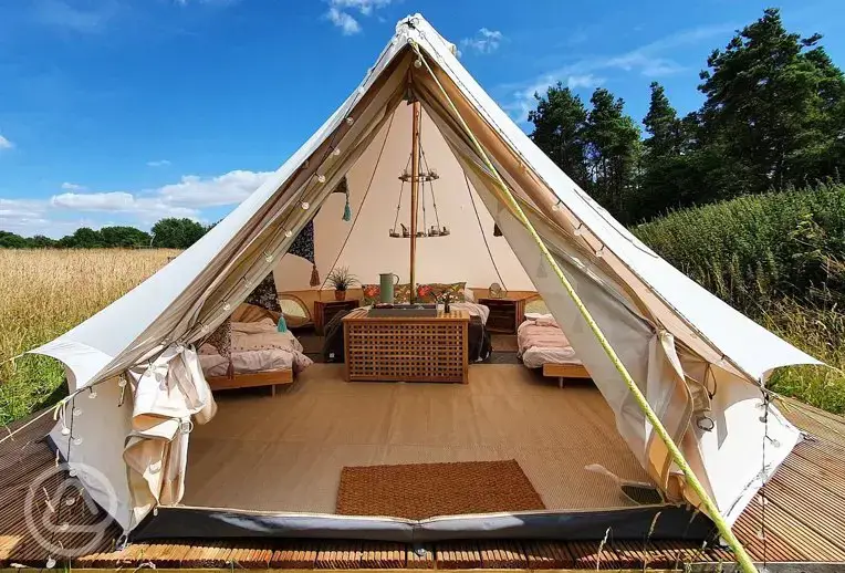 Bell tent with a double bed and single futon beds